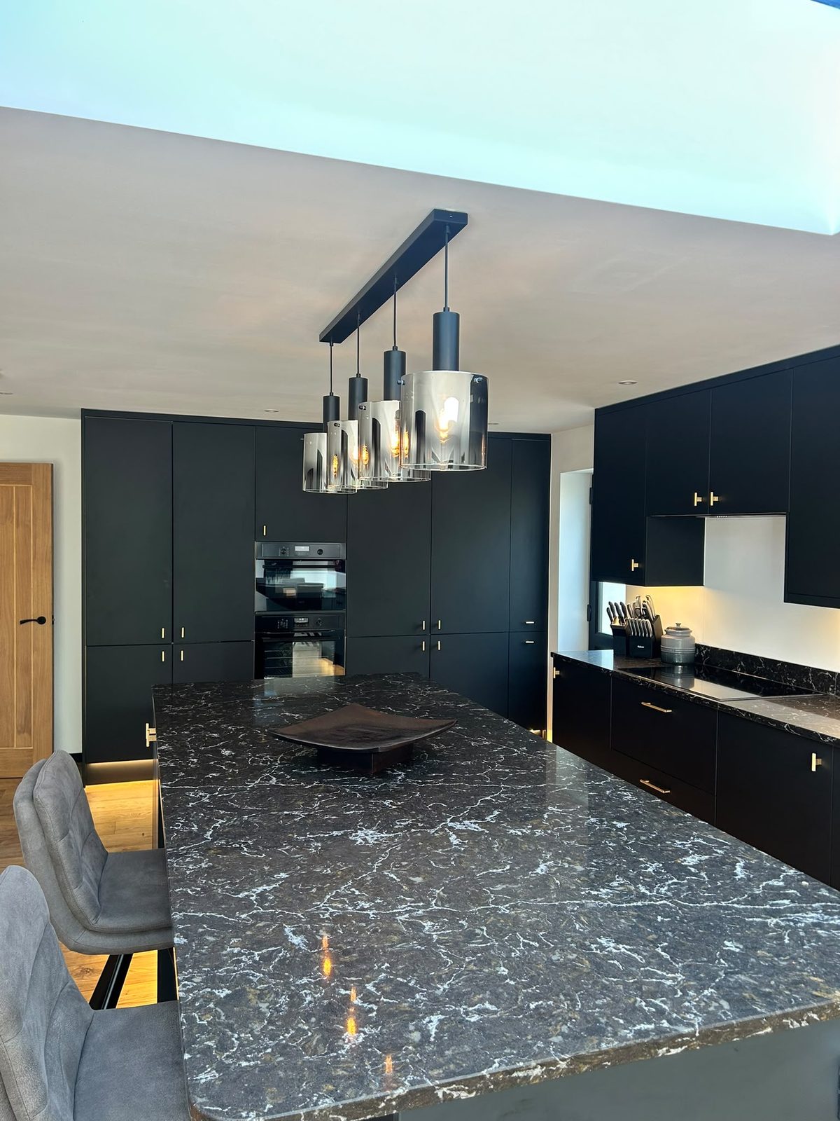 Close up of the veined black stone island worktop