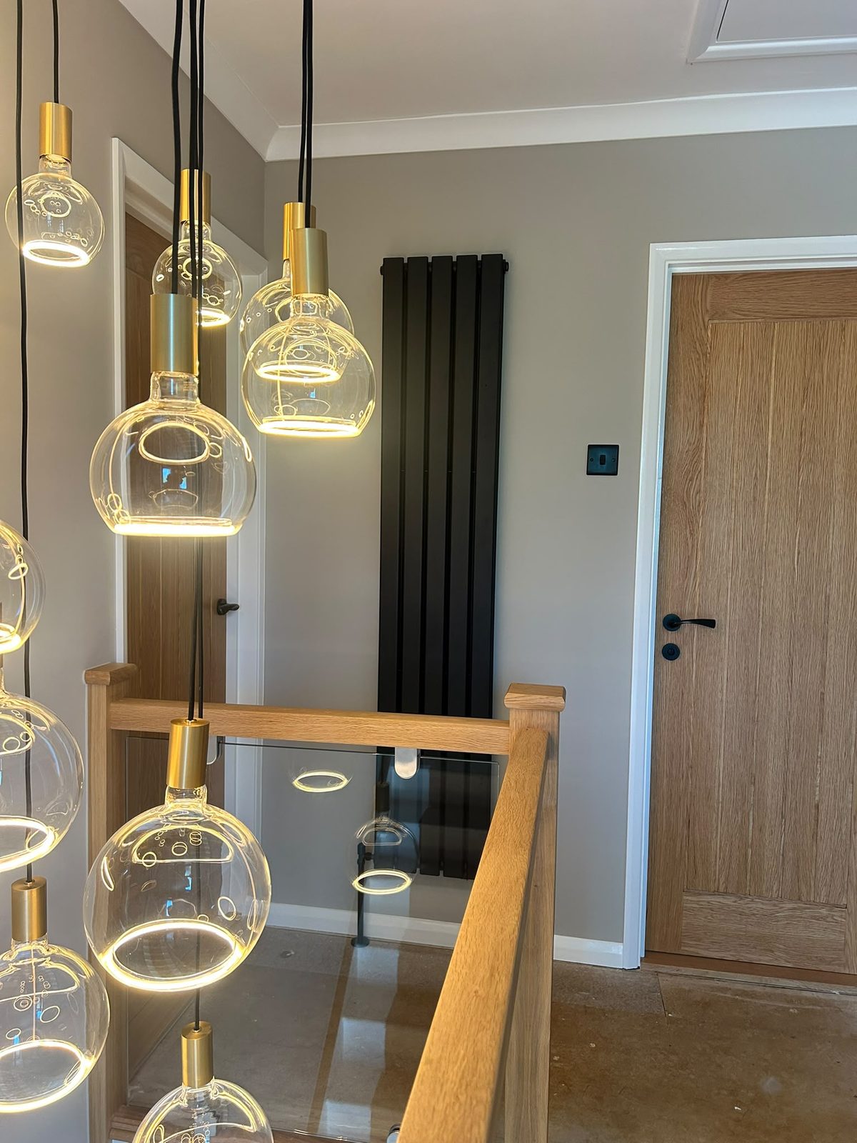 Cluster of glass globe pendants hanging through the stairwell
