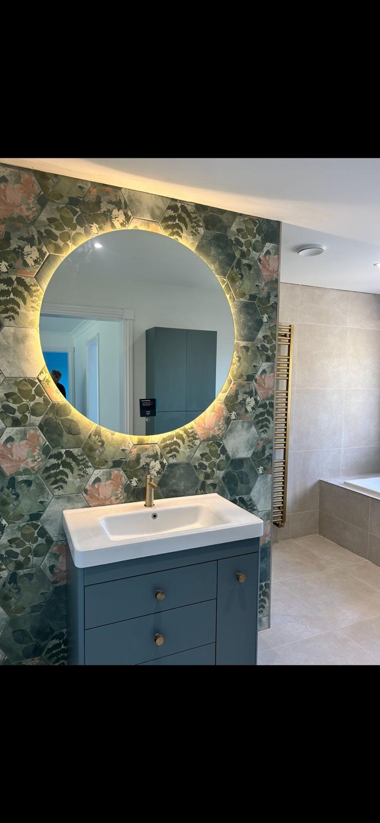 Backlit round mirror with floral hexagon feature tiles