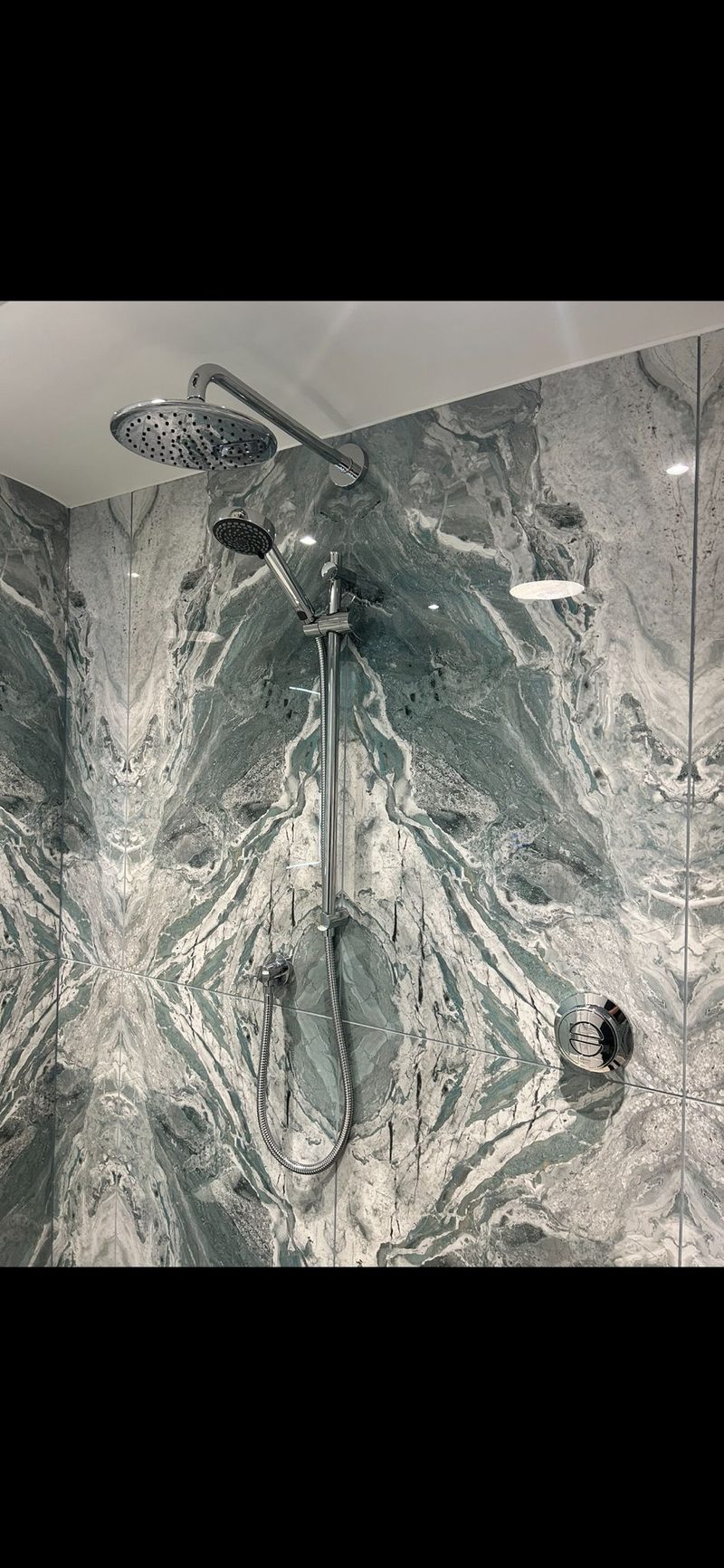 Book-matched green marble shower panels