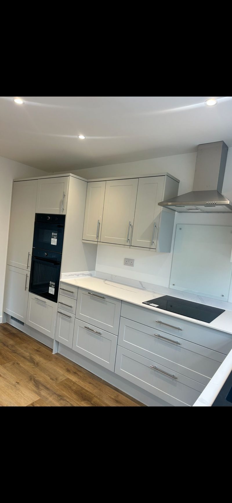 White shaker kitchen with oak floor